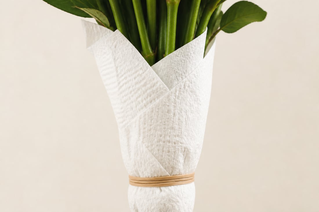 Paper towel secured with an elastic band